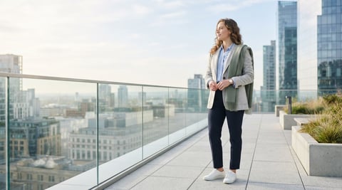 A young professional standing on an airy urban terrace