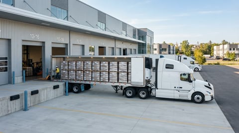 Transport truck at a modern loading dock in Quebec